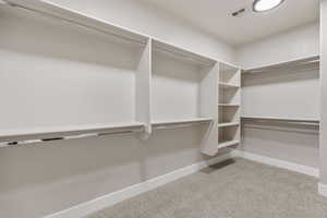Spacious closet with carpet floors