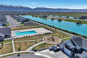 Aerial perspective of suburban area with a water and mountain view and a pool