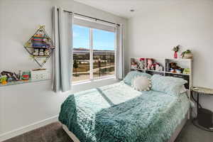 Carpeted bedroom with baseboards