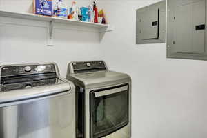 Washroom with electric panel and washer and dryer