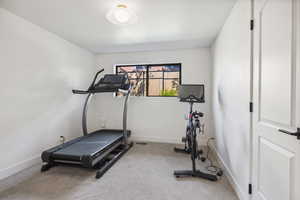 Workout room with carpet and baseboards