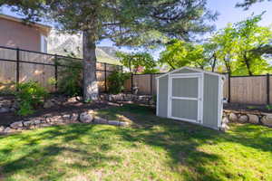 View of yard featuring a storage shed and an outdoor structure