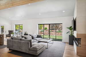 Living area featuring recessed lighting, light wood finished floors, beamed ceiling, and high vaulted ceiling