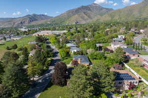 Aerial overview of property's location featuring a mountainous background and nearby suburban area