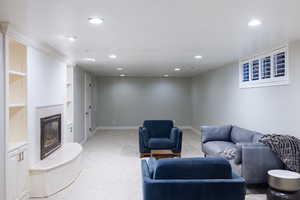 Living room with recessed lighting, a fireplace, light colored carpet, and baseboards