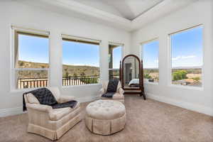 Sitting room with carpet floors and baseboards