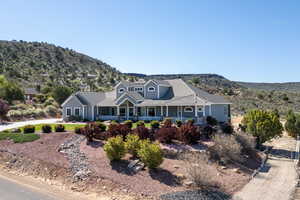 View of front of house featuring covered porch, a mountain view, and a tile roof