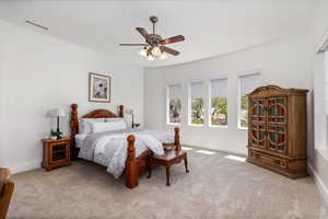 Carpeted bedroom featuring baseboards and ceiling fan