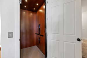 Elevator featuring wood ceiling and recessed lighting