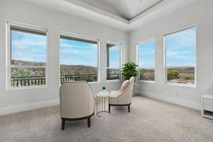 Sitting room featuring light carpet and a mountain view