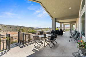 View of patio with grilling area and outdoor dining space