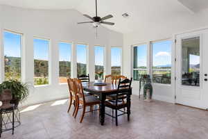 Sunroom featuring lofted ceiling and tile patterned flooring