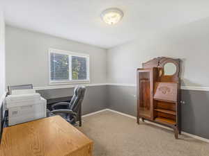 Carpeted home office with baseboards