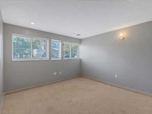 Unfurnished room with carpet, baseboards, and recessed lighting