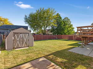 View of yard featuring a patio area, a storage shed