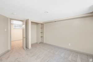 Unfurnished bedroom featuring baseboards, visible vents, a closet, and light colored carpet