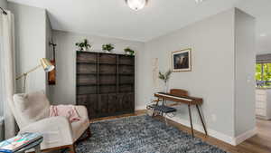 Living area with wood finished floors and baseboards