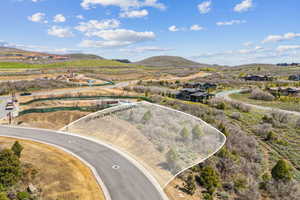 Aerial view of property's location with a mountainous background and property boundaries highlighted