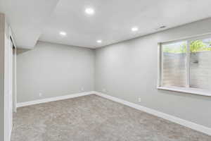 Below grade area featuring recessed lighting, carpet floors, and baseboards