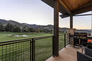 Balcony featuring a mountain view and a grill