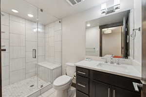 Full bath featuring a shower stall, toilet, vanity, recessed lighting, and tile patterned floors