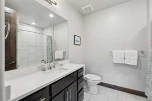 Bathroom featuring baseboards, toilet, a shower with shower curtain, vanity, and recessed lighting