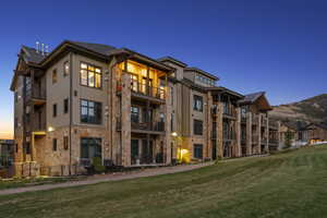 View of property at dusk