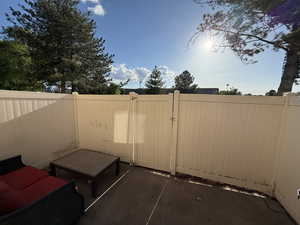 View of patio featuring fence