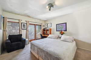Bedroom with carpet flooring and access to exterior