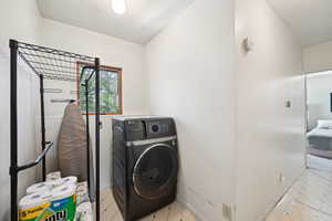 Laundry area with washing machine and dryer and baseboards