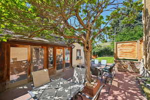 View of patio featuring outdoor dining area and cooling unit