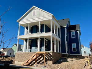 View of front of house with a large porch and a shingled roof