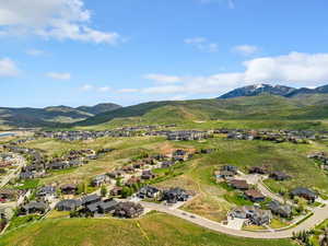 Aerial overview of property's location with nearby suburban area and mountains