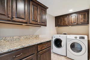 Laundry area with cabinet space and separate washer and dryer