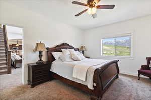 Bedroom with carpet flooring, baseboards, and a ceiling fan