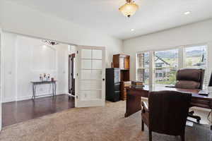Office area featuring light colored carpet, recessed lighting, light wood finished floors, and baseboards