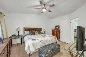 Bedroom featuring lofted ceiling, light carpet, and ceiling fan