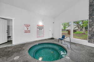 View of pool featuring a hot tub