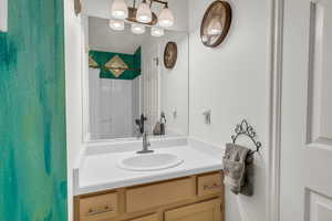 Bathroom with a shower with shower curtain and vanity
