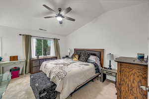 Bedroom with vaulted ceiling and a ceiling fan