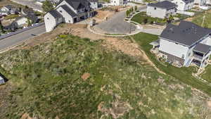 Aerial view of property and surrounding area with nearby suburban area
