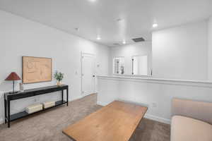 Carpeted office space with baseboards and recessed lighting