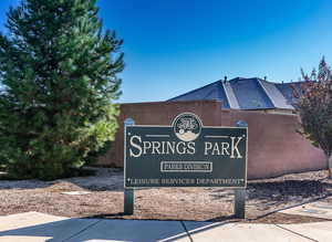 Community / neighborhood sign featuring fence