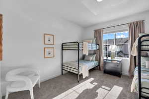 Bedroom featuring carpet and baseboards