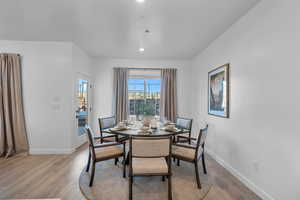 Dining area with baseboards, light wood-type flooring, and recessed lighting