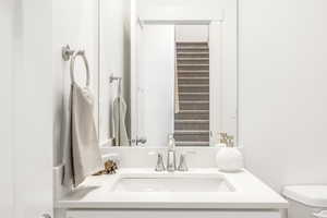 Half bathroom with toilet and vanity