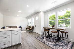 Dining area with baseboards, recessed lighting, and light wood-style floors