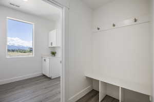 Mudroom with wood finished floors and baseboards