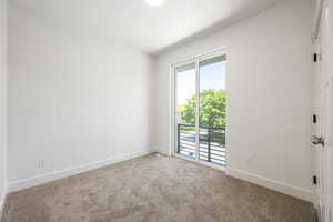 Carpeted empty room with baseboards