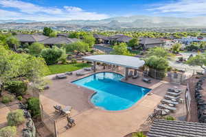 Community pool with fence, a patio area, a mountain view, and a residential view